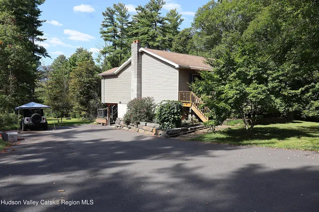 a view of a yard with plants and trees