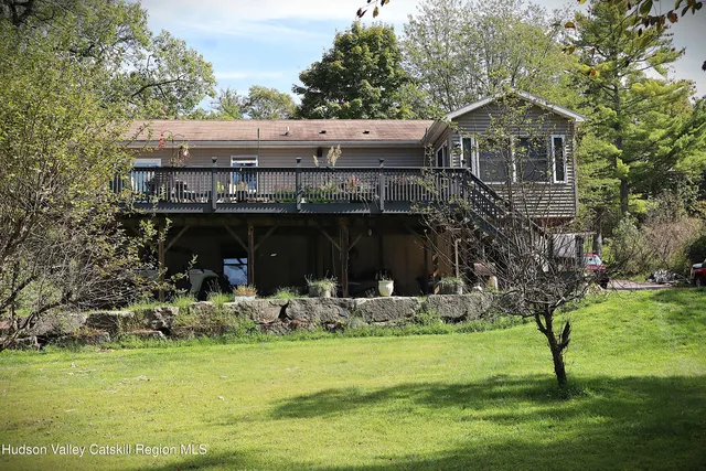 a view of a house with a yard balcony and sitting area