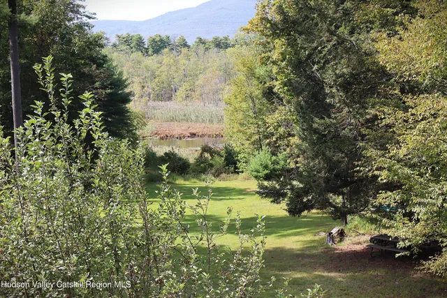 a view of backyard with small garden and deck