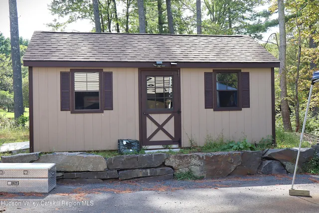 a front view of a house with trees