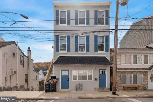 a front view of a building with a street