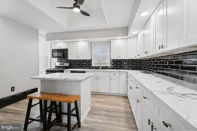 a kitchen with stainless steel appliances kitchen island granite countertop a sink and cabinets