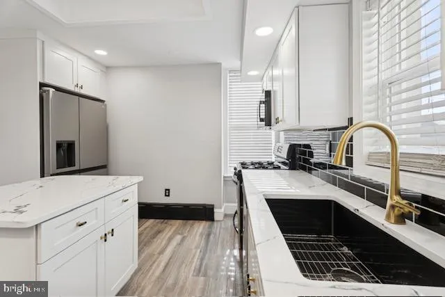 a kitchen with a sink stove and cabinets