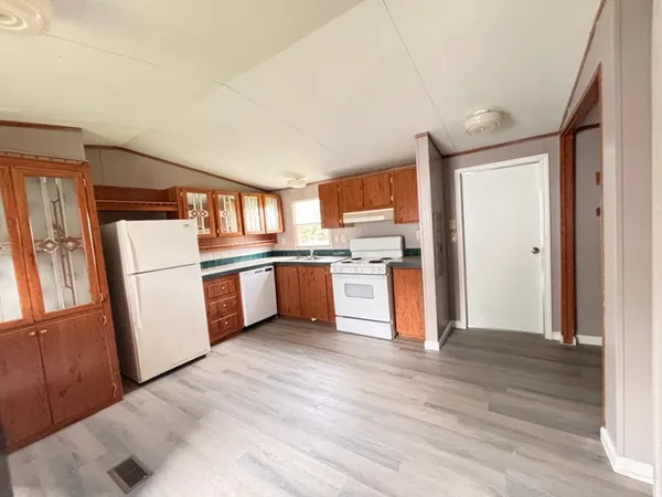 a kitchen with stainless steel appliances a refrigerator and a stove top oven