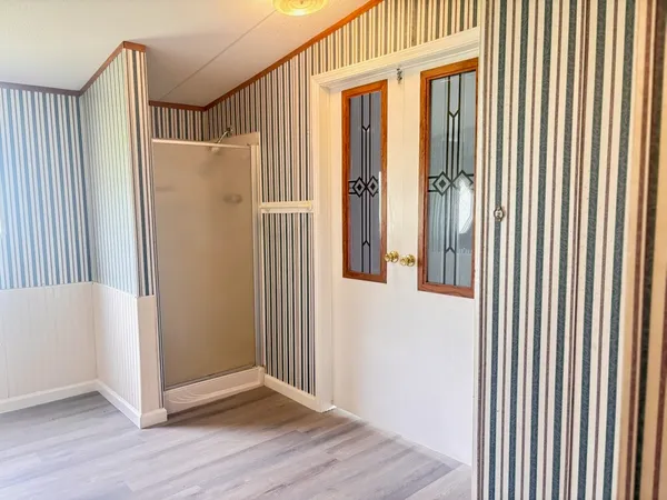 an entryway with wooden floor and door