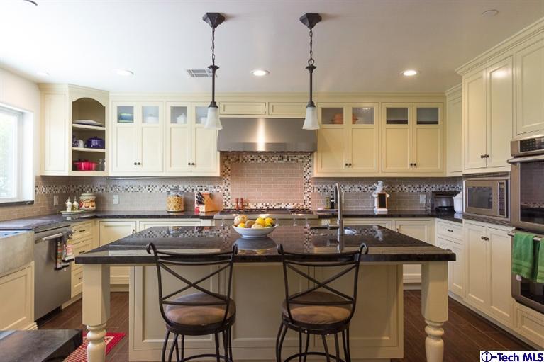 3830 Shadow Grove Road Pasadena, CA 91107 - Photo 7 of 31 a kitchen with stainless steel appliances granite countertop a table chairs in it and white cabinets