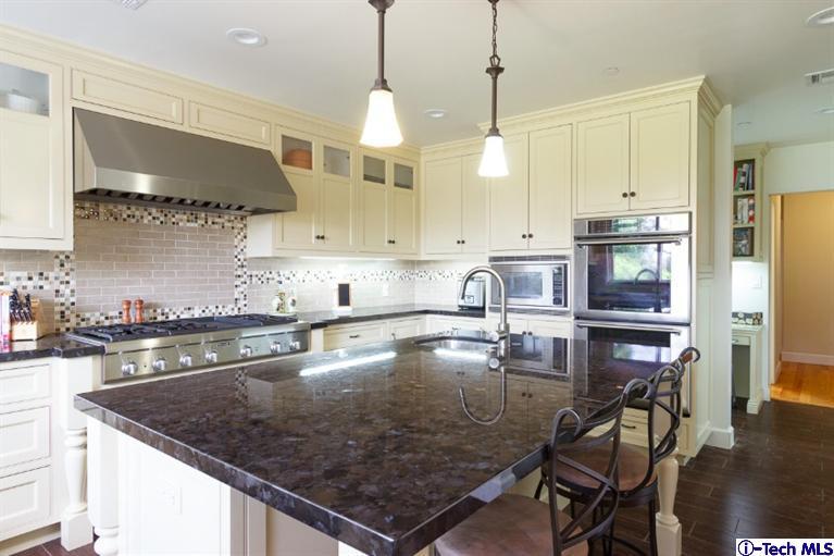3830 Shadow Grove Road Pasadena, CA 91107 - Photo 8 of 31 a kitchen with stainless steel appliances granite countertop a sink a stove and a wooden cabinets
