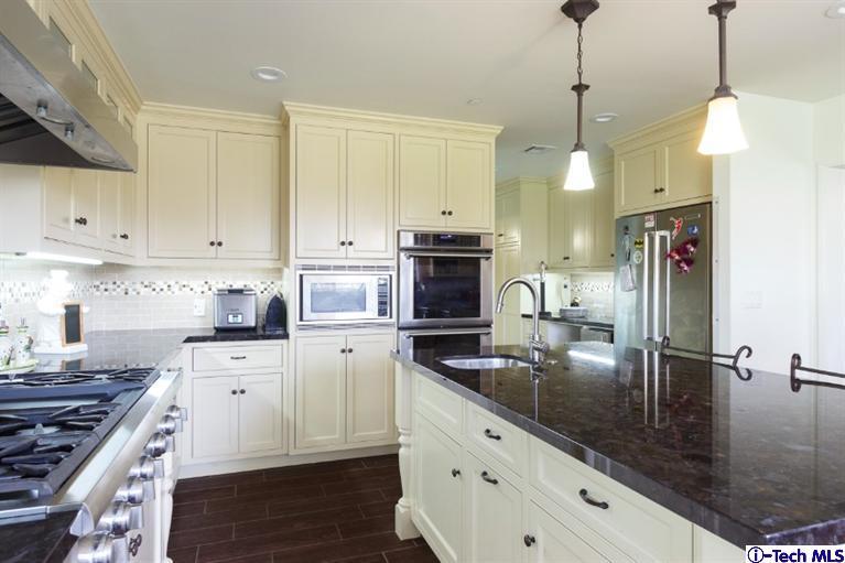 3830 Shadow Grove Road Pasadena, CA 91107 - Photo 9 of 31 a kitchen with stainless steel appliances granite countertop a sink a stove and a wooden floors