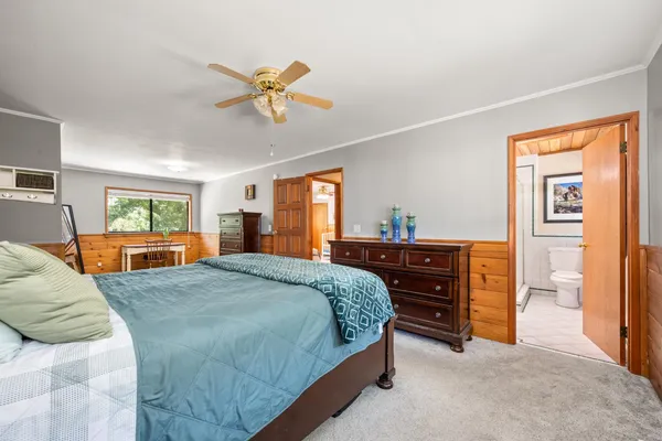 a bedroom with a bed and a window