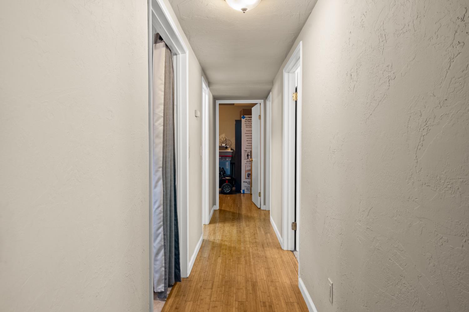 2162 Painted Pony Road Somerset, CA 95684 - Photo 42 of 72 a view of a hallway with wooden floor and a bathroom