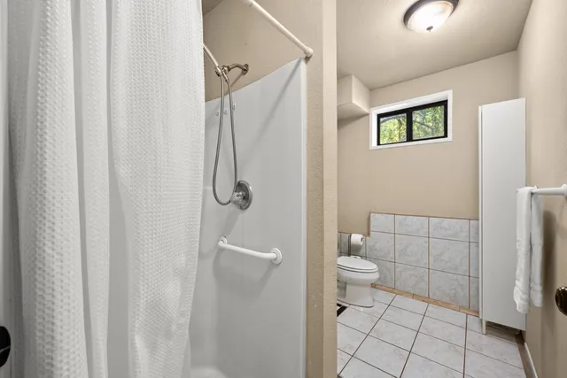 a roof deck with table and chairs a barbeque with potted plants