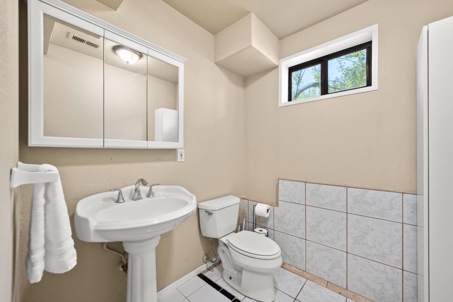 2162 Painted Pony Road Somerset, CA 95684 - Photo 46 of 72 a bathroom with a toilet sink and mirror