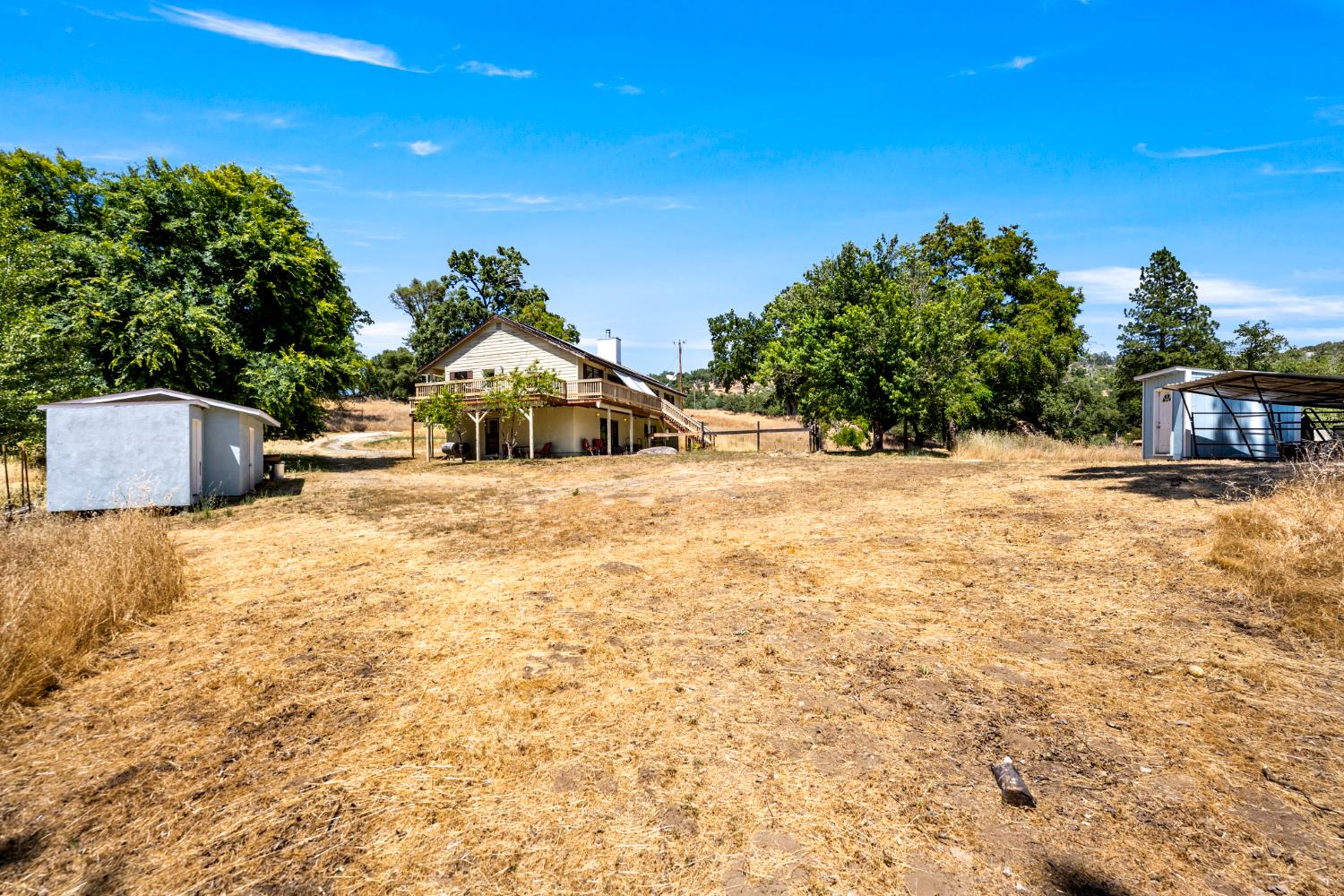 2162 Painted Pony Road Somerset, CA 95684 - Photo 56 of 72 a view of a house with floor to ceiling windows and a tree