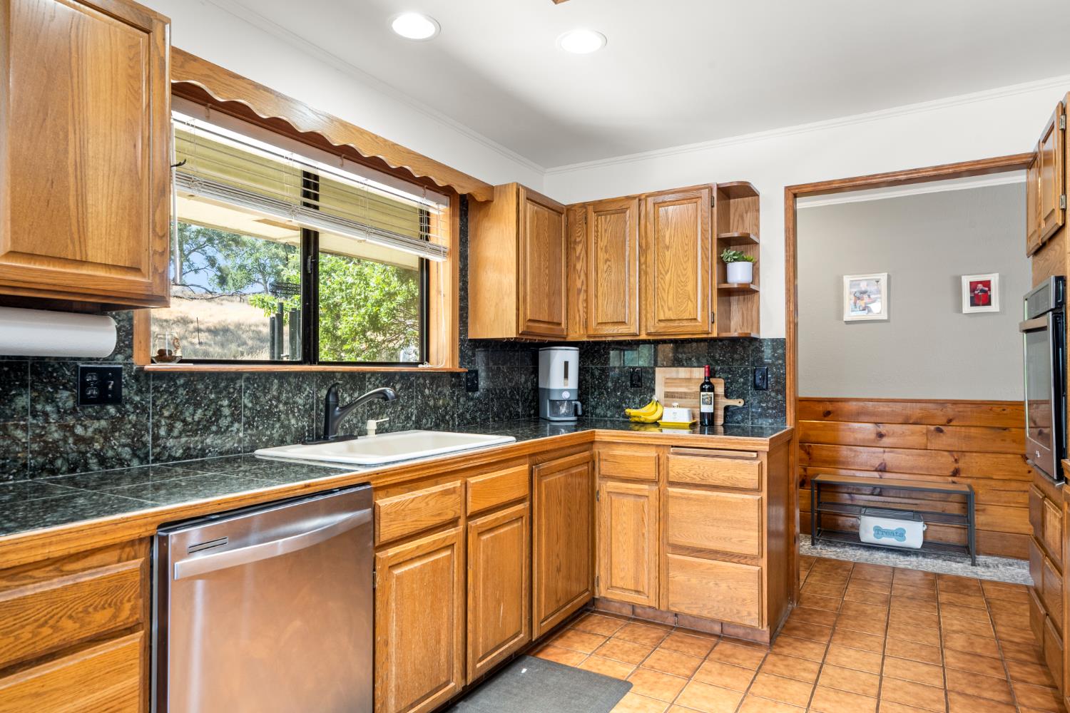 2162 Painted Pony Road Somerset, CA 95684 - Photo 9 of 72 a kitchen with stainless steel appliances granite countertop a sink and cabinets