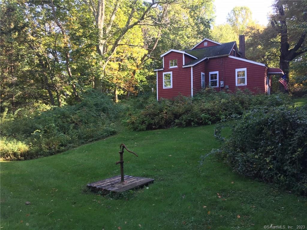 87 Rucum Road Roxbury, CT 06783 - Photo 1 of 1 a view of a big house with a big yard and large trees