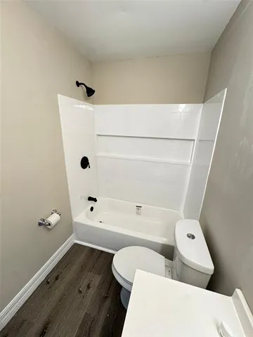 a bathroom with a toilet and a bathtub