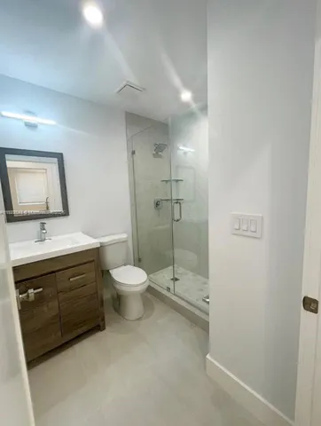 a bathroom with a toilet a sink and shower