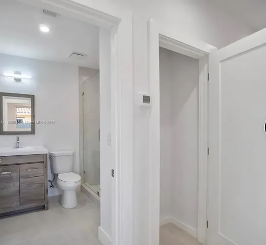 a bathroom with a toilet sink and a mirror