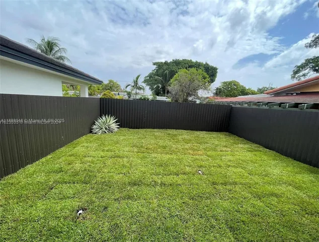a view of a house with backyard and porch