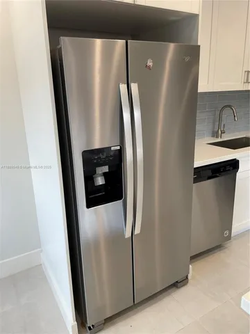 a view of a refrigerator in kitchen