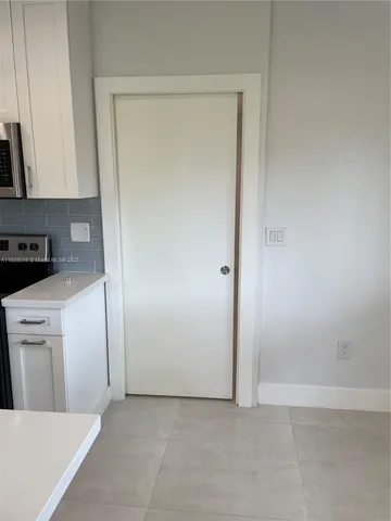 a view of a kitchen from the hallway