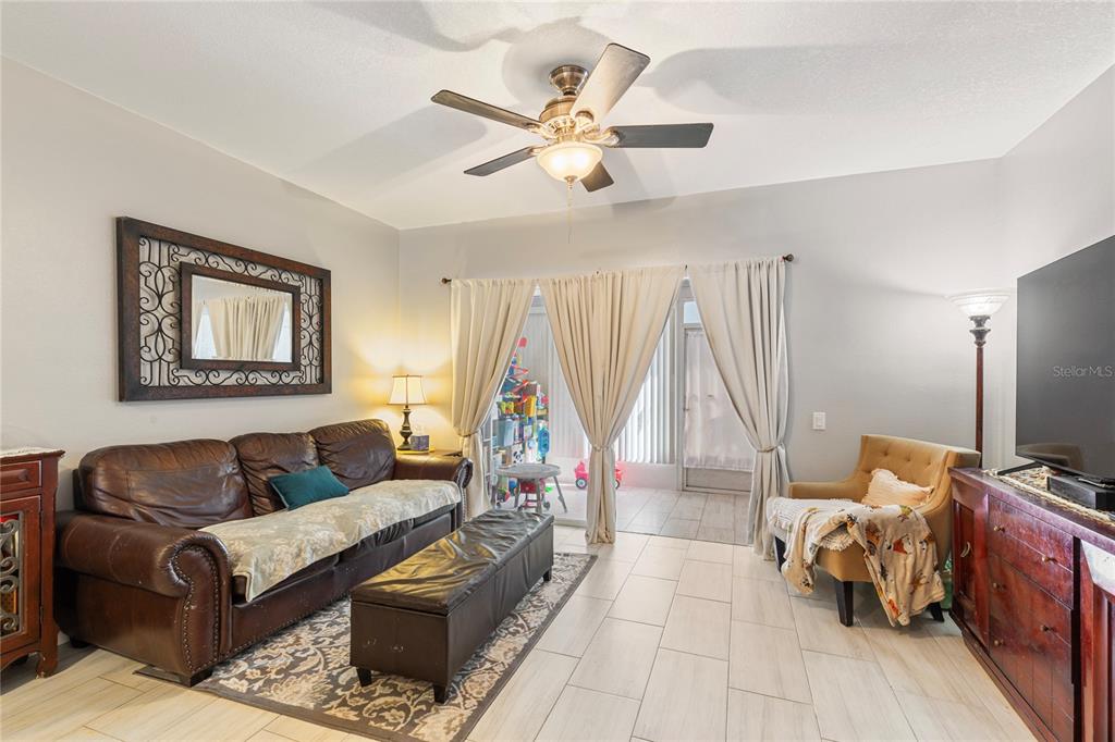 291 Countryside Key Boulevard Oldsmar, FL 34677 - Photo 11 of 34 a living room with furniture and a flat screen tv