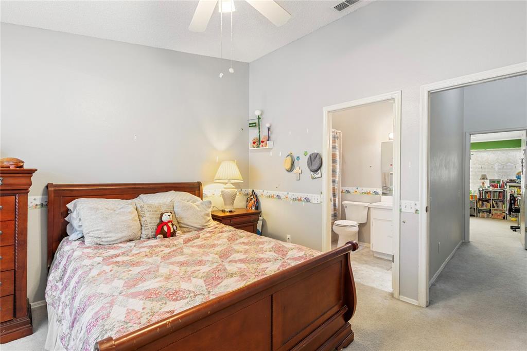 291 Countryside Key Boulevard Oldsmar, FL 34677 - Photo 13 of 34 a bed room with a bed and a chair