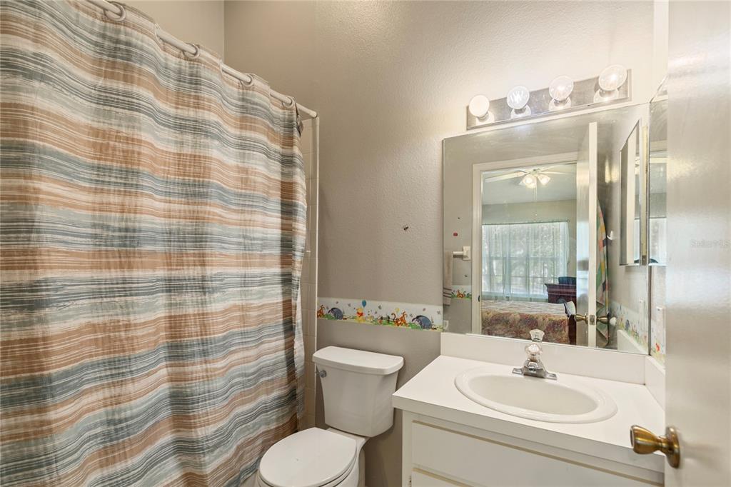 291 Countryside Key Boulevard Oldsmar, FL 34677 - Photo 16 of 34 a bathroom with a sink a toilet and shower curtain