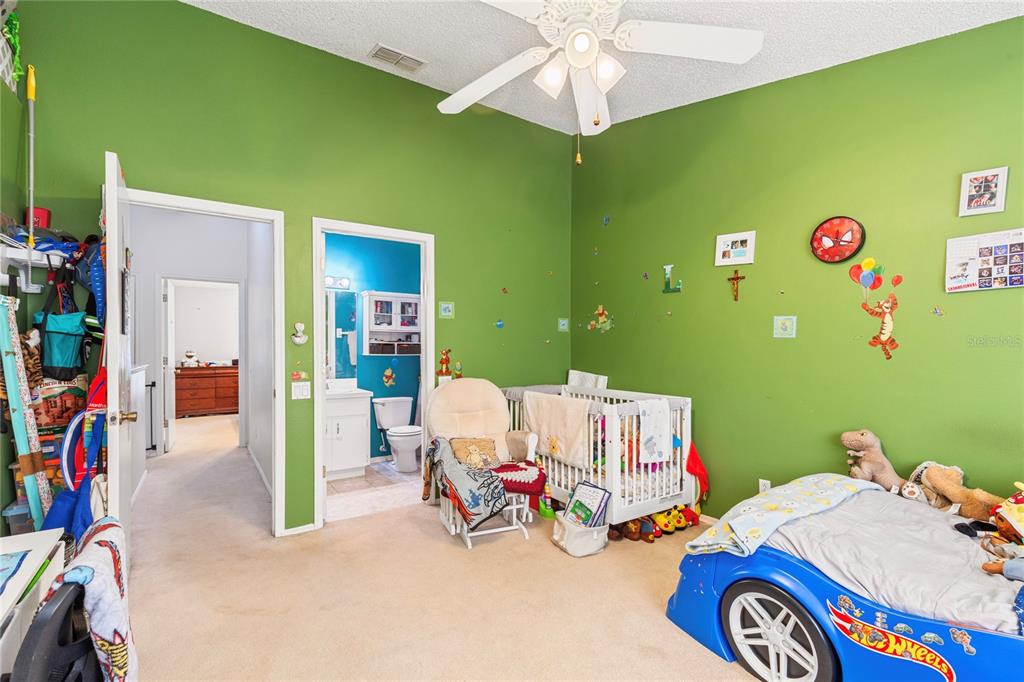 291 Countryside Key Boulevard Oldsmar, FL 34677 - Photo 18 of 34 a bedroom with a bed and a chandelier