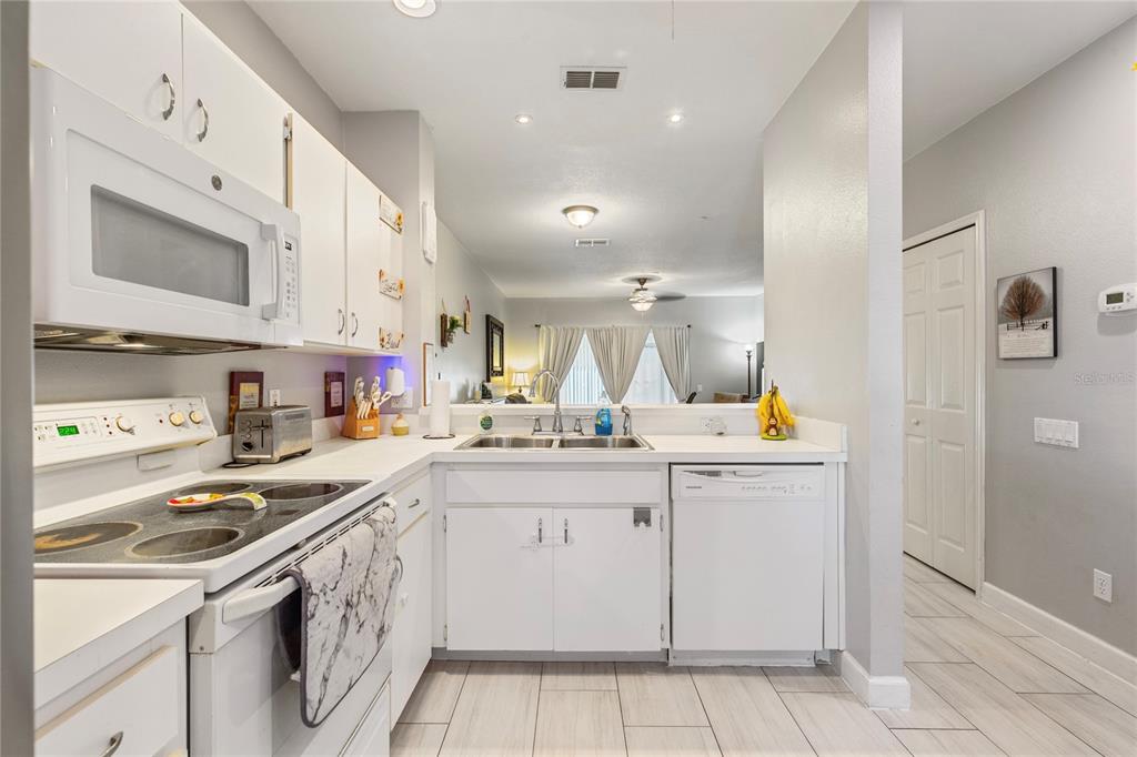 291 Countryside Key Boulevard Oldsmar, FL 34677 - Photo 5 of 34 a kitchen with sink cabinets and stove