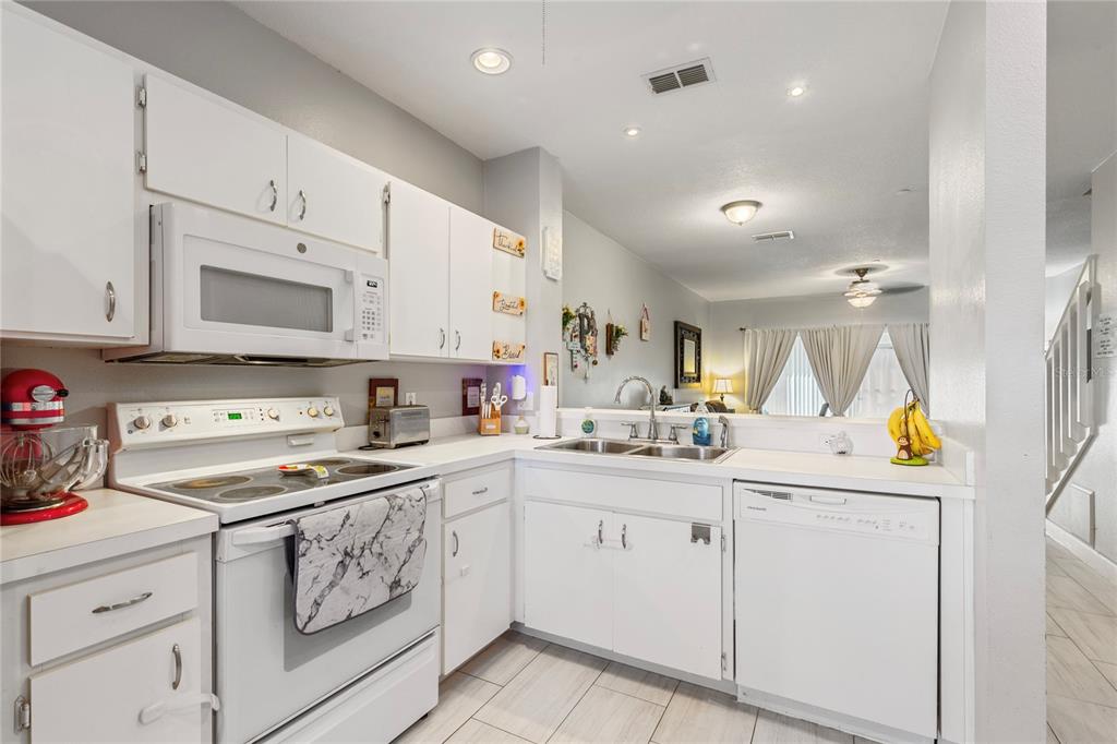 291 Countryside Key Boulevard Oldsmar, FL 34677 - Photo 6 of 34 a kitchen with a sink a stove and cabinets