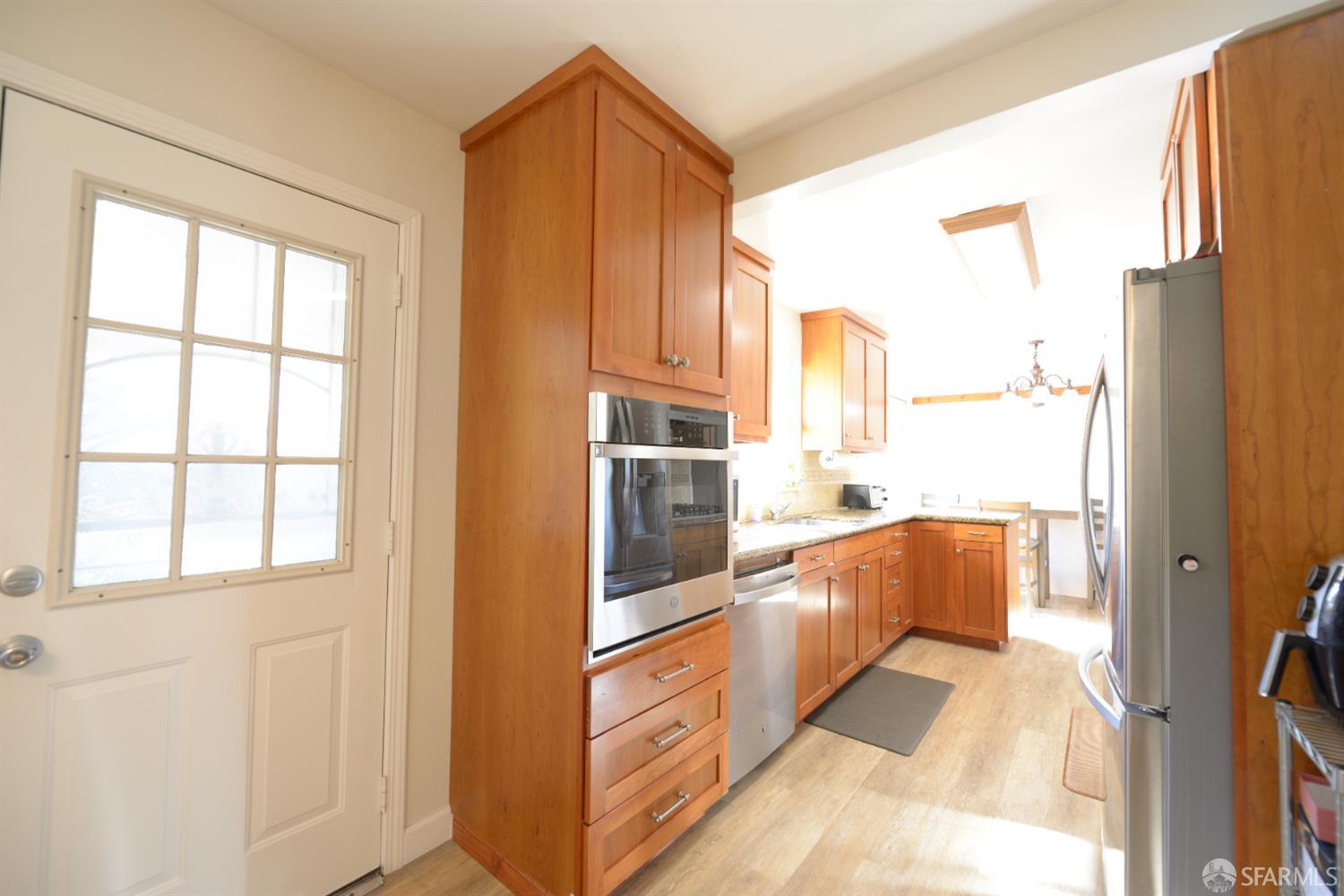 601 Garin Avenue Hayward, CA 94544 - Photo 24 of 27 a view of a kitchen with a refrigerator and cabinets