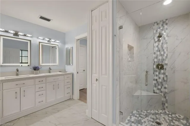 a spacious bathroom with a double vanity sink mirror and shower