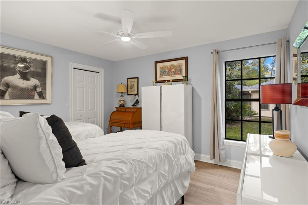 2259 Queens Way Naples, FL 34112 - Photo 22 of 29 a bedroom with a bed and a painting on the wall