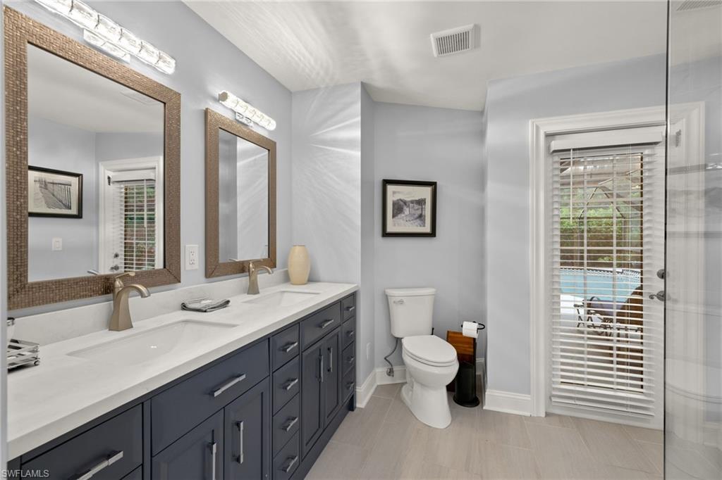 2259 Queens Way Naples, FL 34112 - Photo 23 of 29 a bathroom with a double vanity sink and a window