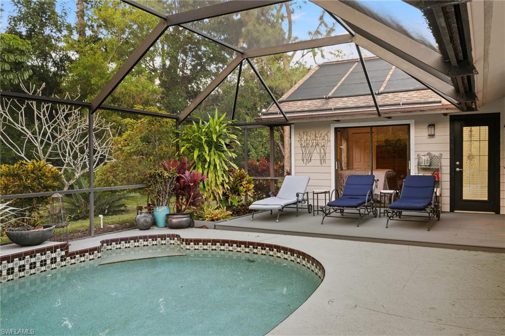 2259 Queens Way Naples, FL 34112 - Photo 29 of 29 a view of swimming pool with lawn chairs and a barbeque