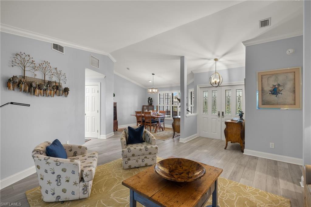 2259 Queens Way Naples, FL 34112 - Photo 8 of 29 a living room with furniture and wooden floor