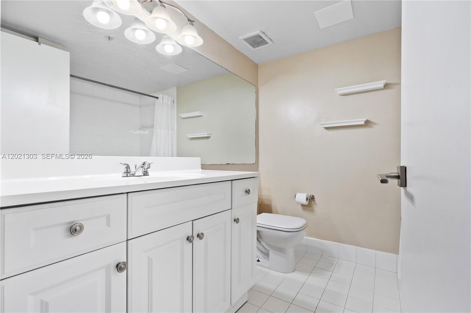 2123 Renaissance Boulevard, Unit 201 Miramar, FL 33025 - Photo 14 of 22 a bathroom with a double vanity sink mirror and toilet