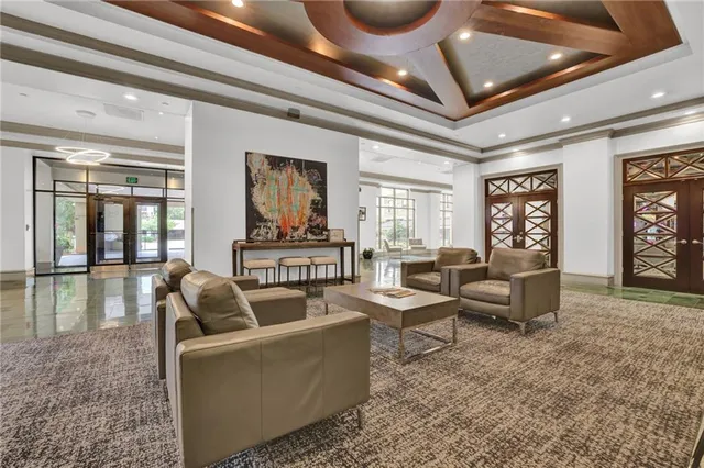 a living room with fireplace furniture and a large window