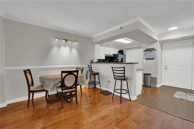 a kitchen with a table chairs refrigerator and microwave