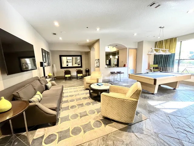 a living room with furniture wooden floor and a flat screen tv