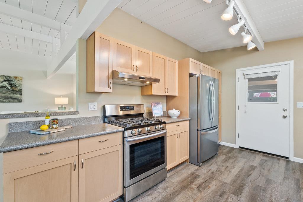 416 Semple Avenue Aptos, CA 95003 - Photo 12 of 45 a kitchen with stainless steel appliances a stove a sink cabinets and a window