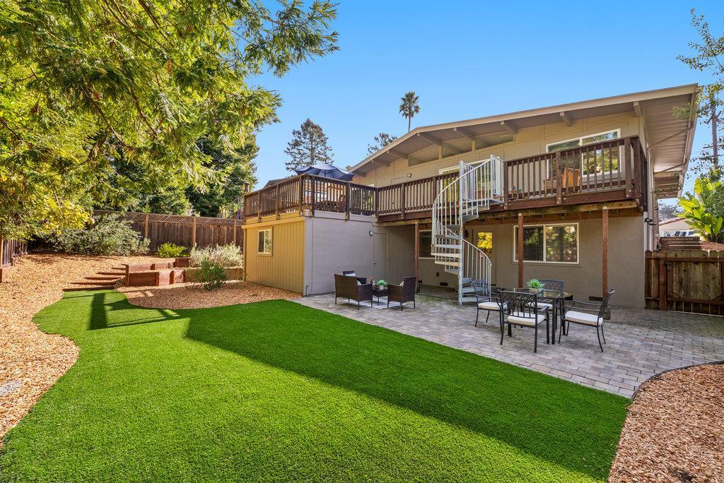 416 Semple Avenue Aptos, CA 95003 - Photo 36 of 45 a view of a patio with table and chairs and potted plants with large tree