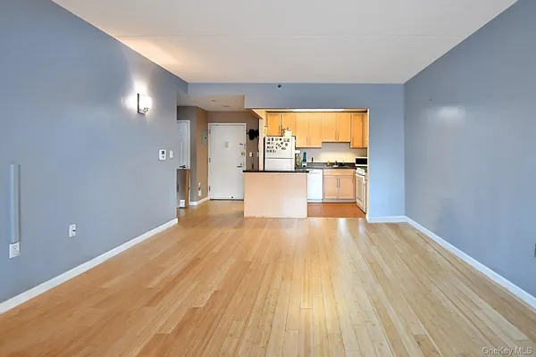 a view of a room with wooden floor and a window