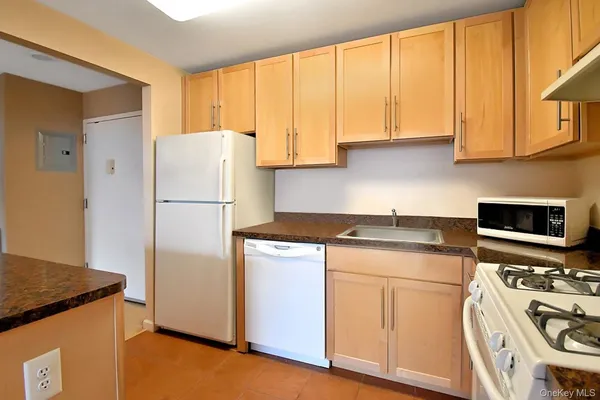 a kitchen with a refrigerator a stove a microwave and cabinets