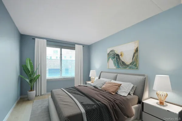 a bedroom with a bed and a painting on the wall