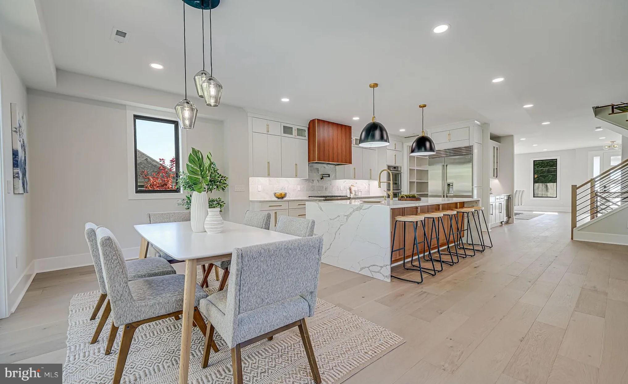 1927 Griffith Road Falls Church, VA 22043 - Photo 11 of 33 a kitchen with stainless steel appliances kitchen island granite countertop a sink a stove a dining table and chairs