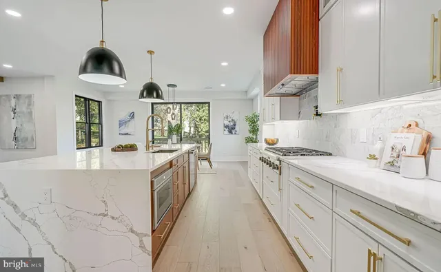 a kitchen with stainless steel appliances white cabinets and a sink