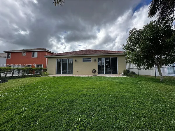 front view of a house with a garden