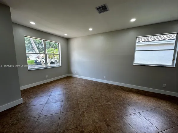 a view of an empty room and a window